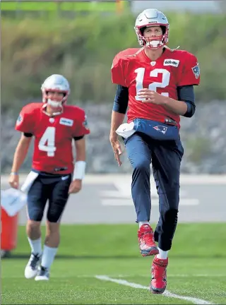  ?? NANCY LANE PHOTOS / BOSTON HERALD FILE ?? Patriots quarterbac­k Tom Brady is followed by Jarrett Stidham at practice in September of last season.