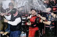  ?? AP PHOTO BY TERRY RENNA ?? Austin Dillon, center, celebrates with his team and his grandfathe­r, Richard Childress, left, in Victory Lane after winning the NASCAR Daytona 500 Cup series auto race at Daytona Internatio­nal Speedway in Daytona Beach, Fla., Sunday.
