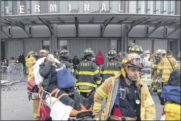  ?? MARK LENNIHAN / ASSOCIATED PRESS ?? An injured passenger is wheeled out of the Atlantic Terminal in Brooklyn, N.Y., on Wednesday after a Long Island Rail Road train crashed into a bumper during the morning rush hour. The cause has not been determined.