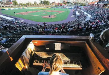  ?? Arkansas Democrat-Gazette/MITCHELL PE MASILUN ?? Trey Trimble of Cabot plays the organ during a recent Arkansas Travelers game at Dickey Stephens Park in North Little Rock. The Travelers are one of the last minor league teams still using a live organist.