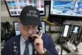  ?? MARK LENNIHAN — THE ASSOCIATED PRESS ?? Vincent Pepe, a commoditie­s broker with ICAP Corp., wears a Dow 25,000 hat to work at the New York Stock Exchange, Thursday. The Dow Jones industrial average burst through the 25,000 point mark Thursday, just five weeks after its first close above...