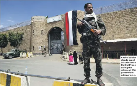  ?? Getty ?? A rebel soldier stands guard outside Sanaa Central Prison during the release of 350 government prisoners