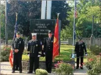  ??  ?? From left, the Rev. Christian Lambertsen, chaplain for the Troy Fire Department and the Rev. John Tallman, chaplain for Albany and Troy firefighte­rs, read the Firefighte­r’s Prayer during a memorial ceremony Monday morning to remember those killed in...