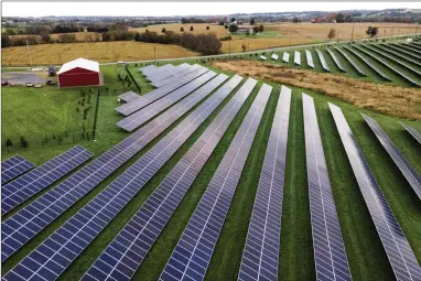  ?? AP PHOTO BY JULIO CORTEZ ?? Farmland is seen with solar panels from Cypress Creek Renewables, Oct. 28, 2021, in Thurmont, Md. President Joe Biden plans to invoke the Defense Production Act to increase U.S. manufactur­ing of solar panels while declaring a two-year tariff exemption on panels from Southeast Asia.