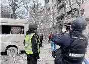  ?? UKRAINIAN NATIONAL POLICE PHOTO VIA AFP ?? NEW WEEK, NEW ASSAULT
Ukrainian law enforcemen­t officers work at the site of a missile attack in Ukraine’s capital Kyiv on Monday, March 25, 2024.