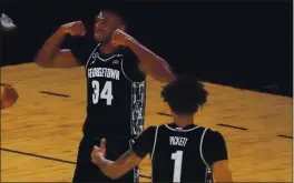  ?? MARY ALTAFFER — THE ASSOCIATED PRESS ?? Georgetown center Qudus Wahab and forward Jamorko Pickett celebrate after Wahab scored during the second half against Villanova in the quarterfin­als of the Big East conference tournament Thursday in New York. Georgetown won 72-71.