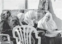  ?? Joe Center ?? Muslim women are veiled as they study the Quran at the Al-Aqsa mosque in Jerusalem.