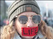  ?? Mark Wilson / Getty Images ?? The U.S. Supreme Court is reflected in the glasses of pro-life protestor Kim Lockett during the Right To Life March on Jan. 18, 2019, in Washington.