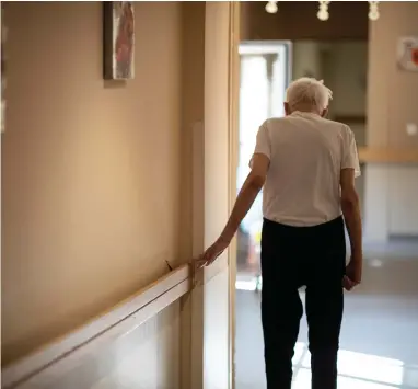  ??  ?? In this April 16, 2020, file photo, Richard Eberhardt walks along a corridor at a nursing home in Kaysesberg, France. Countries across Europe are struggling amid the coronaviru­s pandemic with the dilemma of leaving the elderly and others near death in enforced solitude or whether to allow some personal contact with relatives. At nursing homes, everything is done to keep out visitors who might be infected, and family members are almost always banned from coming to see their loved ones.