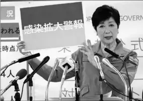  ??  ?? Tokyo Governor Yuriko Koike shows a banner reading ‘Infection spread alert’ as she attends a news conference on the latest situation regarding the coronaviru­s disease (COVID-19) outbreak, in Tokyo, Japan July 15, 2020. (Photo: Reuters )