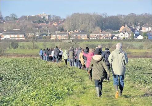  ??  ?? > Protesters from Walmley and Minworth on the fields off Fox Hollies Road which are set to be developed with thousands of homes