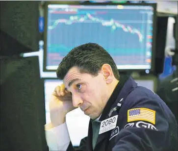  ?? Spencer Platt Getty Images ?? THE DOW JONES industrial average has tumbled 8.5% since reaching a record high Jan. 26. Wall Street considers a loss of 10% or more a “correction.” Above, a trader on the floor of the New York Stock Exchange.