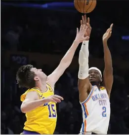  ?? MARCIO JOSE SANCHEZ – THE ASSOCIATED PRESS ?? Lakers guard Austin Reaves, left, was the primary defender against Thunder star guard Shai Gilgeous-Alexander during Monday night's game at Crypto.com Arena.