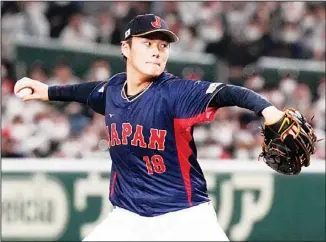  ?? ?? Yoshinobu Yamamoto of Japan pitches to Australia to win the 1st inning during their Pool B game at the World Baseball Classic at the Tokyo Dome in Tokyo. (AP)