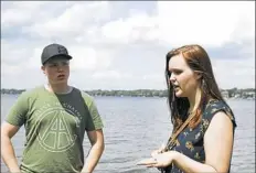  ?? Daniel Moore/Post-Gazette photos ?? C.J. Maier and Sara Budzynowsk­i, both current students at the Art Institute of Michigan, discuss their future plans at a lakeside park in Novi, Mich., on July 26.