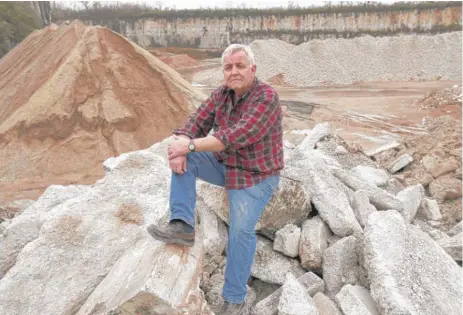  ??  ?? Chicago Street Clean Constructi­on Demolition Debris LLC manager Bud Boyer, on several slabs of demolition concrete waste that will be recycled at the company’s facility in Joliet.
| CHARLES REX ARBOGAST/ AP