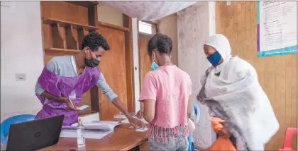  ?? Photo: Nampa/AFP ?? Gearing up… Staff of the National Electoral Board of Ethiopia register people in a registrati­on station in Addis Ababa.