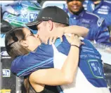  ?? Chris Graythen / Getty Images ?? Ricky Stenhouse Jr., kisses girlfriend and fellow driver Danica Patrick after his win.