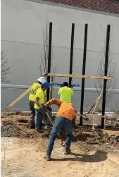  ?? ?? Above
Workers build a steel frame that will hold one of the "Arkansas History" sculptural panels at the Murphy Arts District.