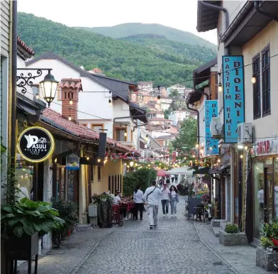  ?? ?? From left: The view across the medieval bridge to Prizren Old Town; shops and cafes line Farkëtarët, Prizren