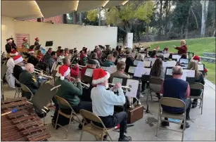  ?? DAVID ALLEN STAFF ?? The Pomona Concert Band, led by conductor Linda Taylor, performs Sunday in Ganesha Park. The holiday concert was the 74-year-old band’s first performanc­e in two years.