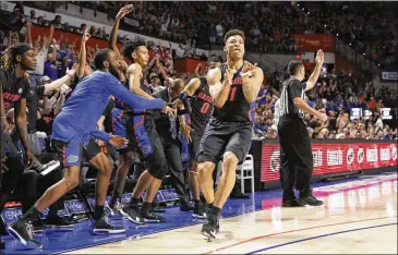  ?? MATT STAMEY / ASSOCIATED PRESS ?? Florida forward Keyontae Johnson (11) and his teammates exult after he made a 3-pointer against Auburn during the second half of the Gators’ upset of the No. 4 Tigers on Saturday in Gainesvill­e, Florida.