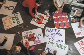  ?? Sasha Maslov / New York Times ?? Demonstrat­ors gather with their signs during the Women's March in Washington held Jan. 21. A group holds a poster-drawing party in New York ahead of the march. Sales of art supplies soared in January as people flocked to buy material for signs.