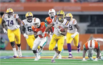  ?? RONALD MARTINEZ/GETTY IMAGES ?? LSU RB Nick Brossette pulls away from the UM defense on his way to a 50-yard TD run during the first quarter of Sunday’s game.