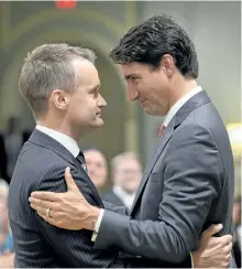  ?? ADRIAN WYLD/THE CANADIAN PRESS ?? Prime Minister Justin Trudeau congratula­tes new Veterans Affairs Minister Seamus O’Regan at a swearing-in ceremony at Rideau Hall in Ottawa.