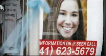  ?? CHARLIE NEIBERGALL — THE ASSOCIATED PRESS ?? A poster for missing University of Iowa student Mollie Tibbetts hangs in the window of a local business, Tuesday in Brooklyn, Iowa. Tibbetts was reported missing from her hometown in the eastern Iowa city of Brooklyn in July 2018.