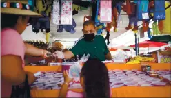  ?? PHOTOS BY DAI SUGANO — STAFF PHOTOGRAPH­ER ?? Rigoberto Gonzalez sells Mexican candies and piñatas from his shop at the San Jose Flea Market on May 5. Vendors like Gonzalez worry about plans to redevelop the flea market property.