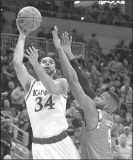  ?? AP/TIMOTHY D. EASLEY ?? Kansas forward Perry Ellis (left) shoots over Maryland forward Robert Carter during the first half of Thursday’s South Region semifinal. Ellis had 27 points and five rebounds to carry the Jayhawks to a 79-63 victory.