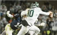  ?? BARRY REEGER/AP ?? Penn State linebacker Abdul Carter (11) tackles Michigan State quarterbac­k Payton Thorne (10) during the second half of a Nov. 26 game in State College.