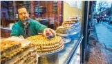  ??  ?? Tamem Al-Sakka is seen working in his pastry shop, ‘Konditorei Damaskus’ in the Neukoeln neighbourh­ood of Berlin.