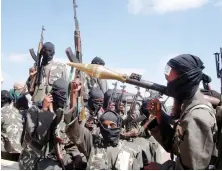  ?? Armed Al-Shabab fighters on pickup trucks prepare to travel into the city just outside Mogadishu. ??