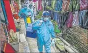  ?? AFP ?? Army health officials walk through an alley during a Covid-19 vaccinatio­n drive for residents in Colombo on Thursday.