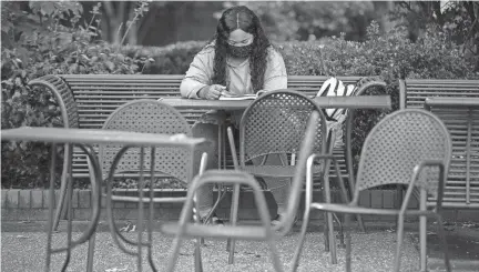  ?? MAX GERSH / THE COMMERCIAL APPEAL ?? Freshman Lauren Adamson, 18, of Cleveland, Tenn., studies for a theater class in a courtyard Aug. 24 on the University of Memphis campus.