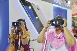  ??  ?? BANGALORE: Indian visitors use virtual reality devices that can be used with a cellphone at the Bengaluru ITE Biz Informatio­n Technology Expo in Bangalore yesterday.—AFP