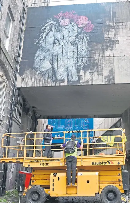  ??  ?? LEGACY: SNIK at work on the artwork organisers say will leave a digital legacy after it is knocked down.