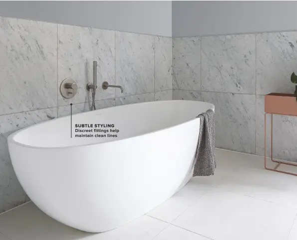  ??  ?? SUBTLE STYLING DISCREET FITTINGS HELP MAINTAIN CLEAN LINES
BELOW ‘OUR FOCUS WHEN CHOOSING PRODUCTS AND FINISHES FOR THE BATHROOM WAS ON CREATING A SENSE OF SPACE AND LIGHT.’ Barcelona free-standing bath, £3,116, Victoria and Albert. Spillo steel wall-mounted bath spout, £238, CP Hart