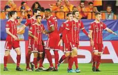  ?? AP ?? Bayern’s Thiago ( third fromleft) celebrates with teammates ■ after scoring his side’s second goal against Sevilla.