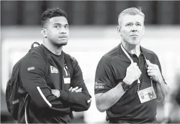  ?? CHARLIE NEIBERGALL AP ?? Tua Tagovailoa (left), who did not do physical drills at the combine, talks with EX-NFL QB Mark Brunell.