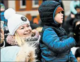  ??  ?? Kellie Taillon, of Hammond, and son Carter wave as Santa arrives via firetruck.