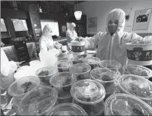  ?? WANG HU / FOR CHINA DAILY ?? Employees pack beef noodles ordered by online customers for delivery at a restaurant in Xiangyang, Hubei province, on March 16.