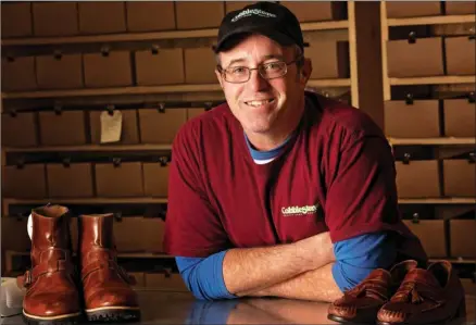  ?? EILISH PALMER/RIVER VALLEY & OZARK EDITION ?? Ty Lanehart leans on the counter in Cobbleston­e Quality Shoe Repair, which opened in October on Oak Street in Conway. Lanehart said he enjoys repairing shoes, purses and other items for customers, but he especially enjoys leatherwor­k. He is a member of a Civil War re-enactment group, and he repairs saddles, too.