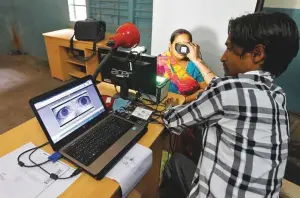  ?? PTI ?? A woman registers for the Aadhaar identity card in New Delhi. The Supreme Court’s order will restrict the programme’s usage to government services only.