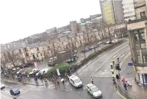  ??  ?? Emergency responders are seen outside Glasgow University. — Reuters