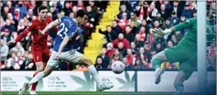  ?? Photo: Paul Ellis / AFP ?? Liverpool’s Andrew Robertson (left) scores the opening goal during the 2-0 win against Everton.