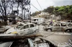  ??  ?? Greece Burnt-out cars line the roads after wildfires hit the seaside resort of Mati