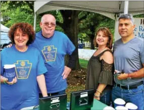  ??  ?? Gate keeper volunteers Rose Obeid and James Brown, both of Berwyn, sell admission tickets to Barb and Phil Rubino of Spring City.
